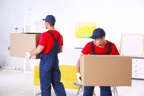 Workers and moving equipment representing ethical removals operations